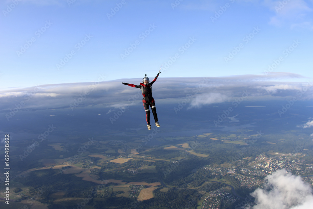 Skydiver girl is falling in the sky.