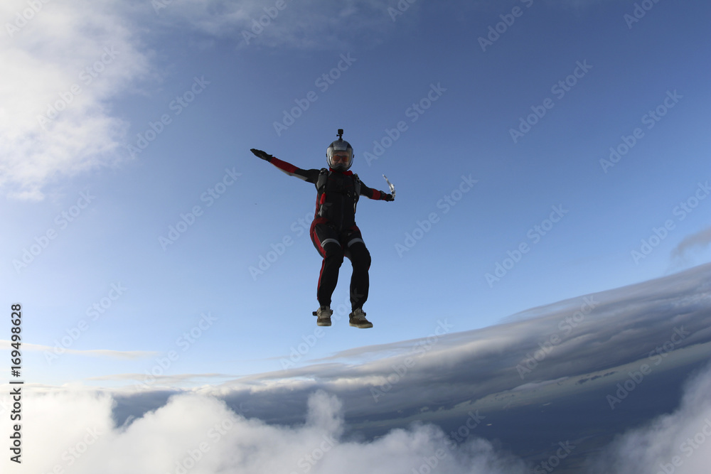 Skydiver girl is falling in the sky. Skydiver girl is falling in the sky.