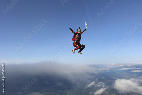 Skydiver girl is falling in the sky.