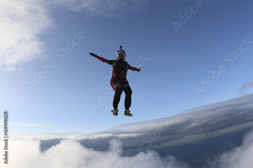 Skydiver girl is falling in the sky.