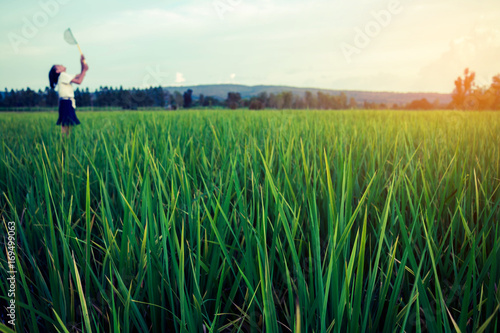 Girl standing on a green field.
