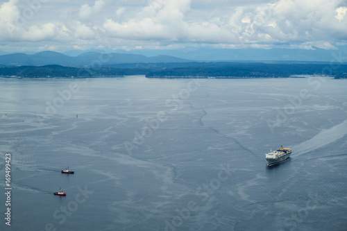 Картината върху платно Tugboats coming to assist a container ship