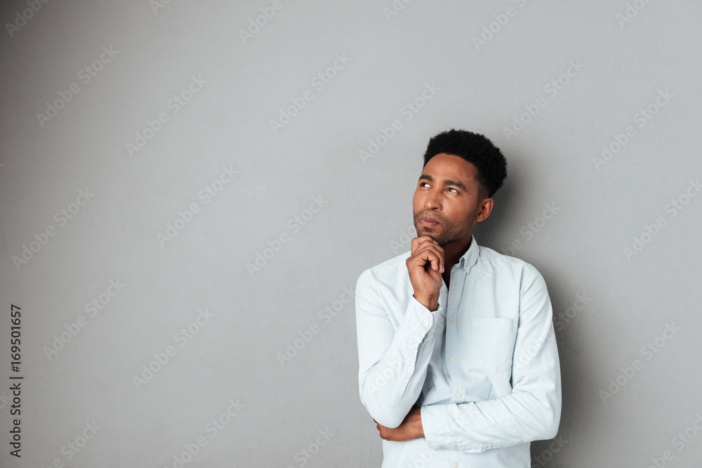 Young pensive african man looking away at copy space Young pensive african man looking away at copy space