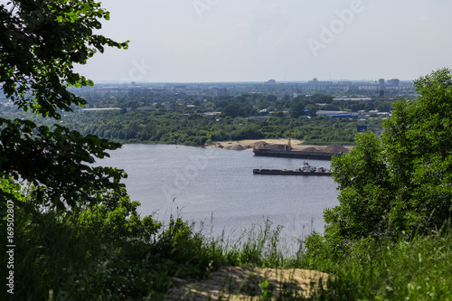 View of the Oka river and the lower part of the city. Nature landscape, city, and house, barges and boats.