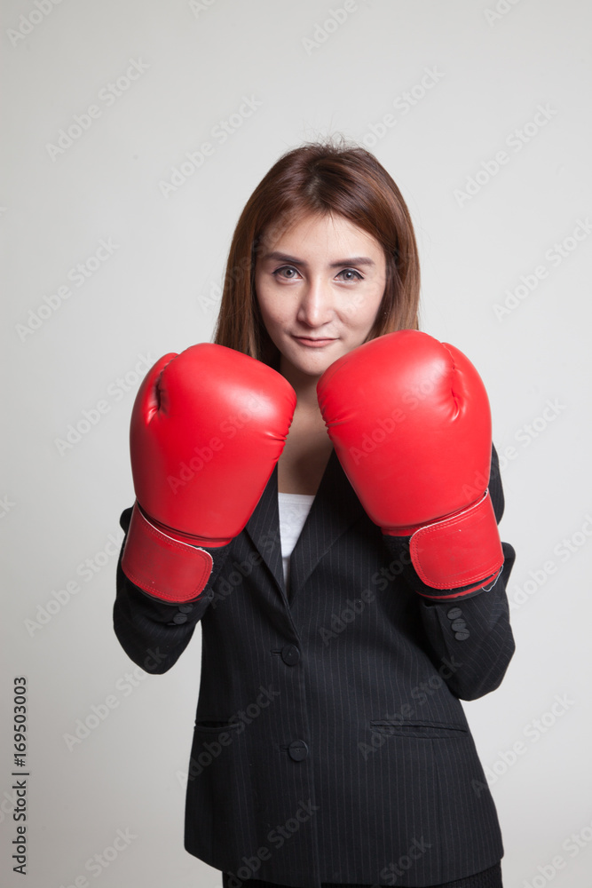 Young Asian business woman with red boxing gloves. Young Asian business woman with red boxing gloves.