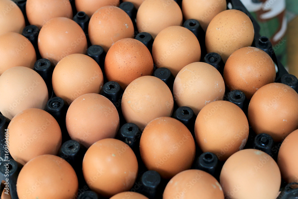 Group of fresh eggs on egg black panel package from a chicken farm in the package retained to sell for cooking at the market. Group of fresh eggs on egg black panel package from a chicken farm in the package retained to sell for cooking at the market.