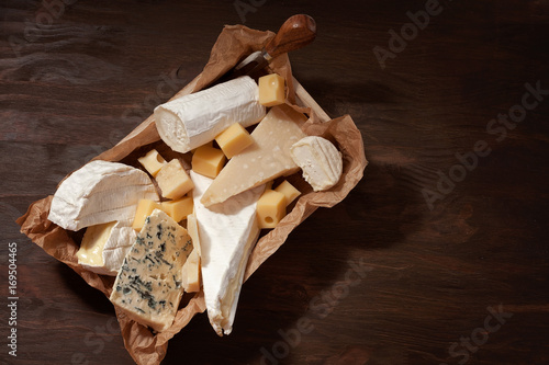 Variety of different cheese with wine. Camembert, goat cheese, roquefort, gorgonzolla, gauda, parmesan, emmental