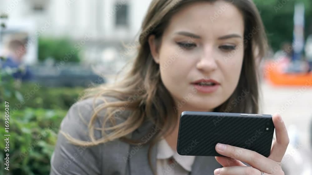 Businesswoman holding smartphone and having a videocall on it, steadycam shot
Businesswoman holding smartphone and having a videocall on it, steadycam shot