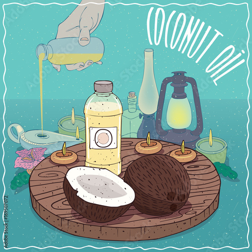 Plastic Bottle of Coconut oil and Coconuts. Hand filling ancient oil lamp. Natural vegetable oil used as fuel for oil lamp