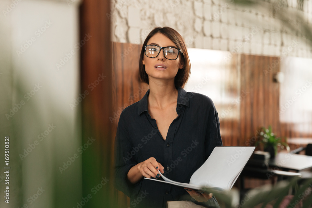 Female manager in eyeglasses with documents in hands Female manager in eyeglasses with documents in hands
