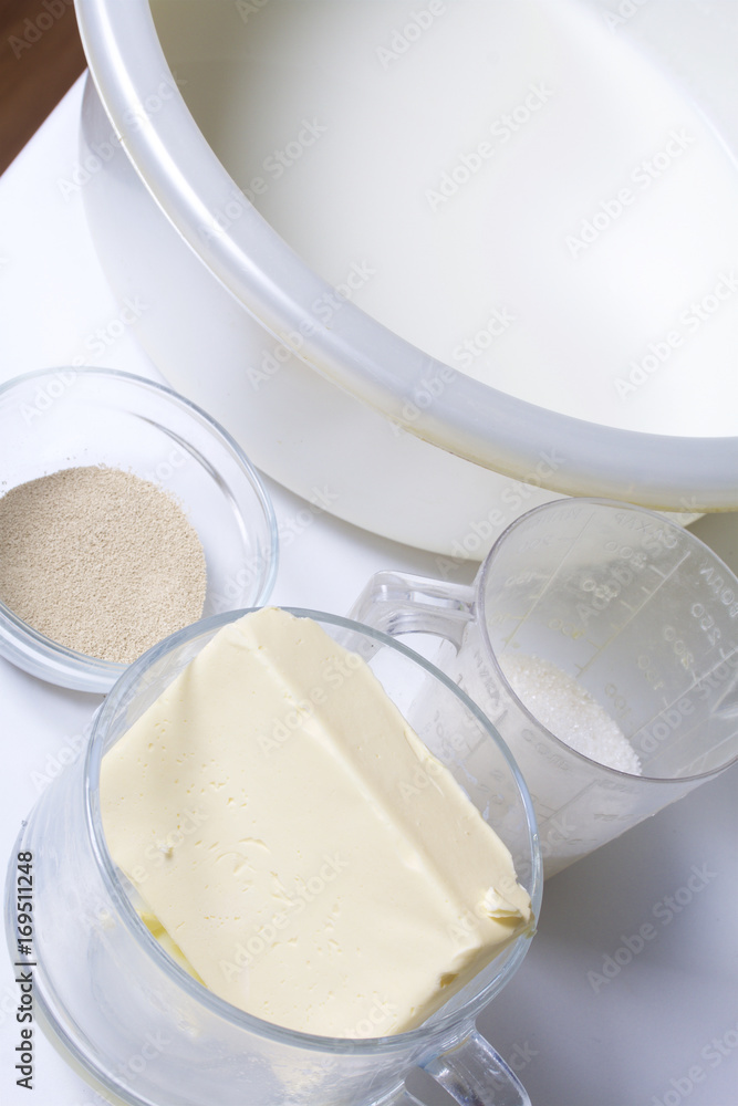 Ingredients for making pastry rolls. Butter, sugar, dry yeast and