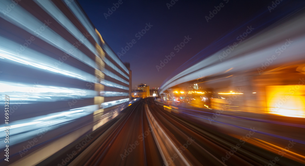 A railway track and skyscrapers seen through a long exposure motion blur in London, England, UK during early evening A railway track and skyscrapers seen through a long exposure motion blur in London, England, UK during early evening