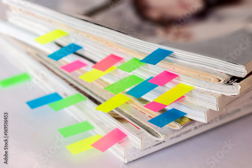 many colorful bookmarks in a magazine with the shallow depth of scene