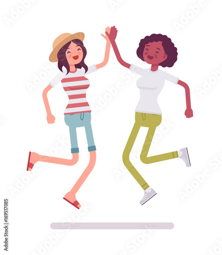 Young women jumping giving high five