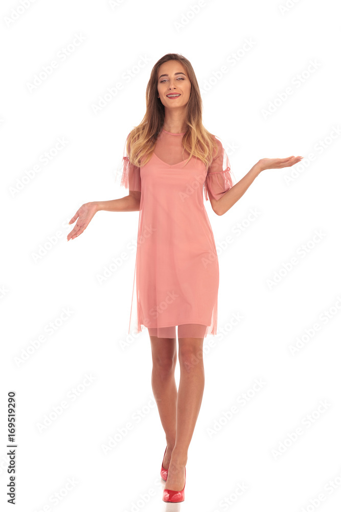 smiling woman in dress walking and welcoming you smiling woman in dress walking and welcoming you