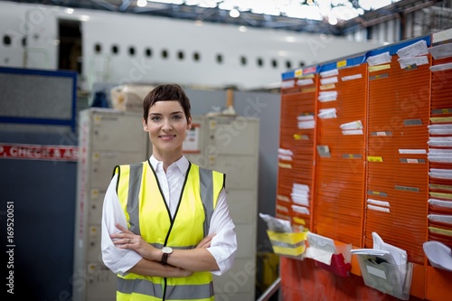 Female aircraft maintenance engineer standing with arms crossed photo