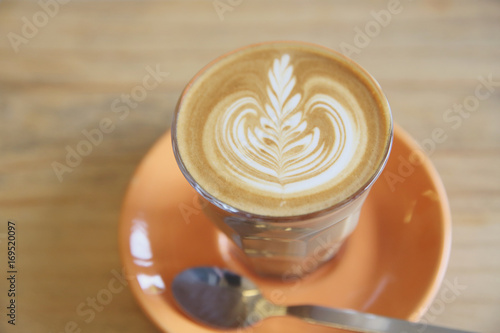 Cappuccino coffee on wood background in coffee shop