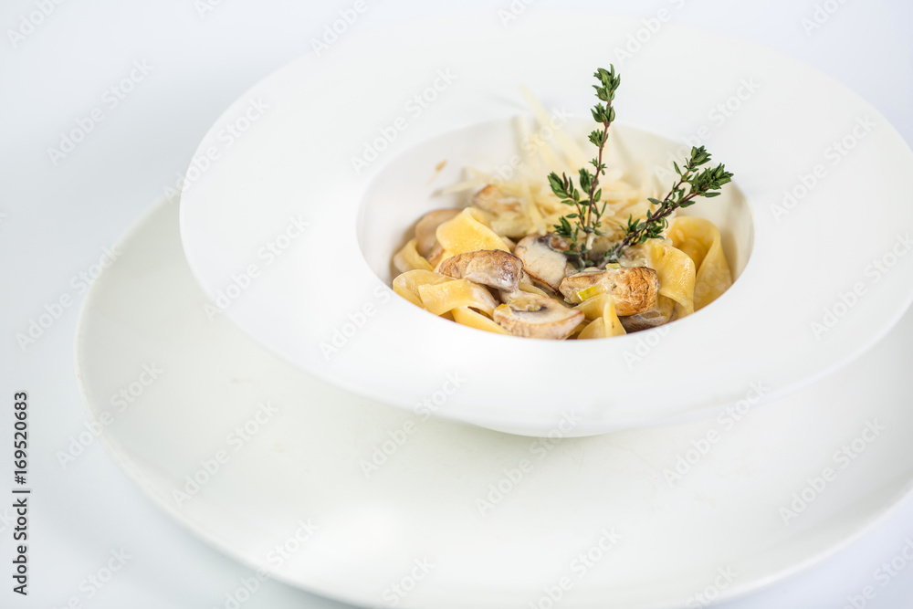Tagliatelle pasta with mushrooms on white background