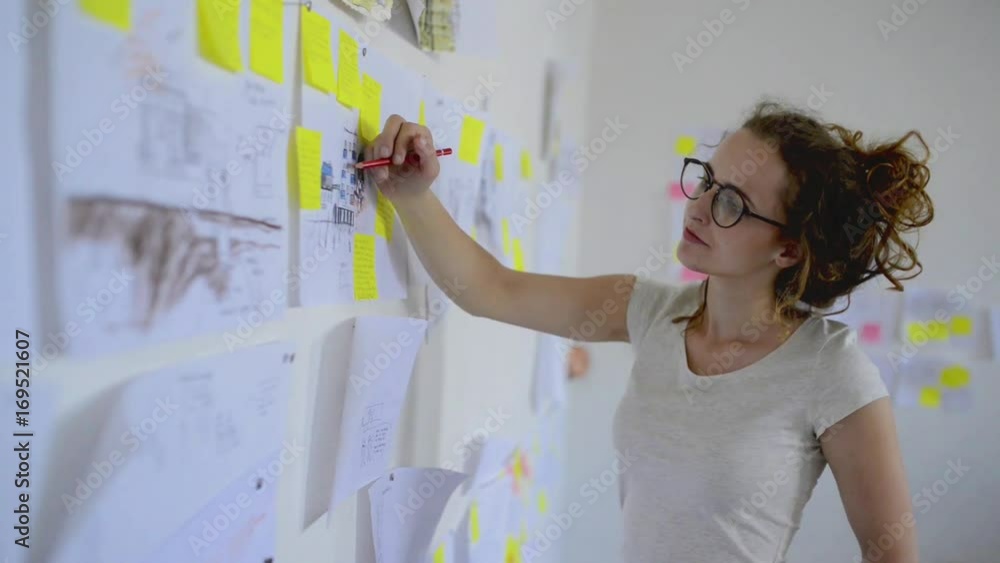 Young architect or designer working on tablet. Young architect or designer working on tablet.