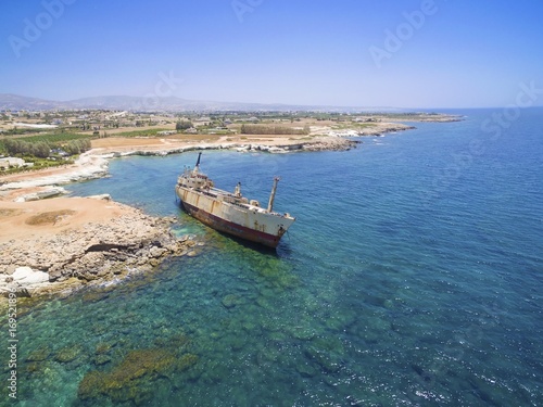 Aerial view of abandoned ship wreck EDRO III in Pegeia  Paphos  Cyprus. The rusty shipwreck is stranded on Peyia rocks at kantarkastoi sea caves  Coral Bay  Pafos  standing at an angle near the shore.