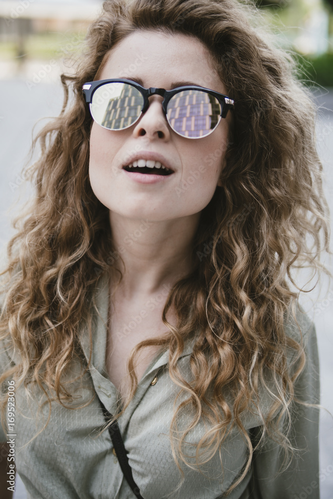 attractive young woman with reflective sunglasses attractive young woman with reflective sunglasses