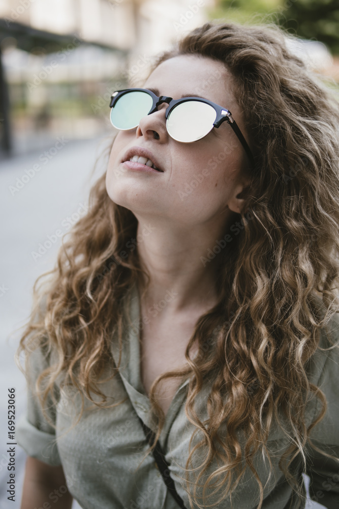 attractive young woman with reflective sunglasses