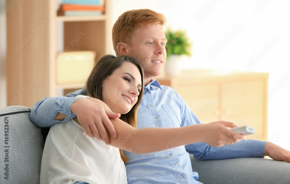 Young couple watching TV at home Young couple watching TV at home