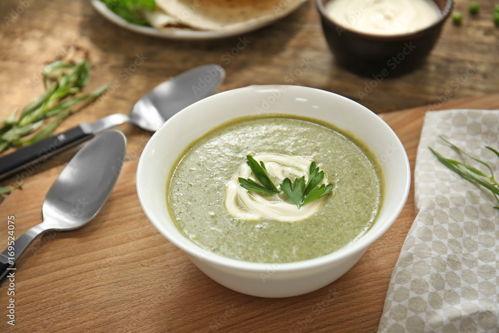 Bowl with fresh kale soup on table Bowl with fresh kale soup on table