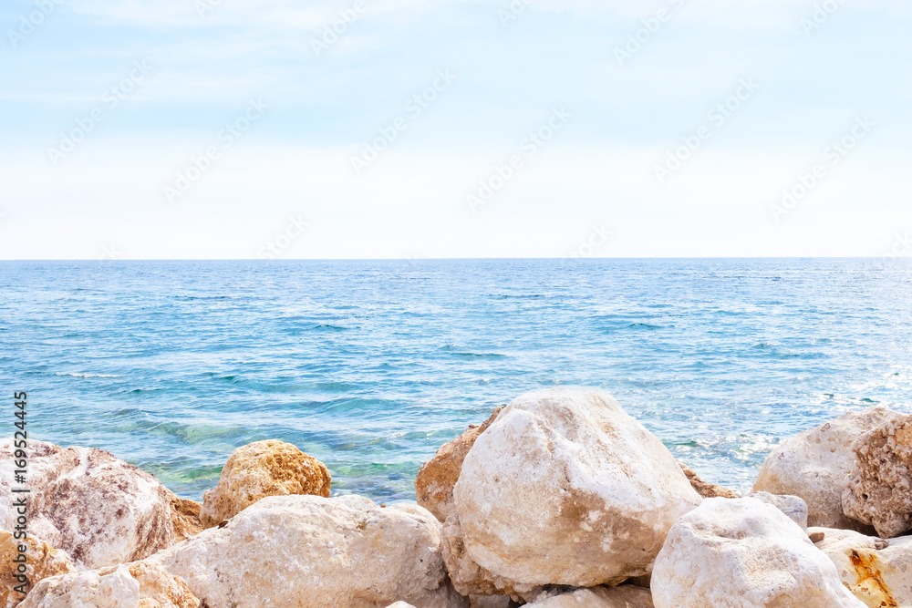 View of blue sea and rocky shore