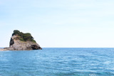 View of blue sea with rocky island