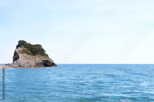 View of blue sea with rocky island