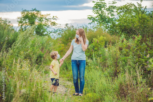 Mother and son in a medical mask because of an allergy to ragweed photo