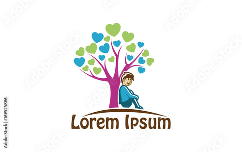 Child resting on a tree with heart-shaped leaves
