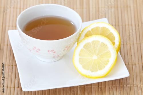 Cup of Lemon tea and fresh lemon slice