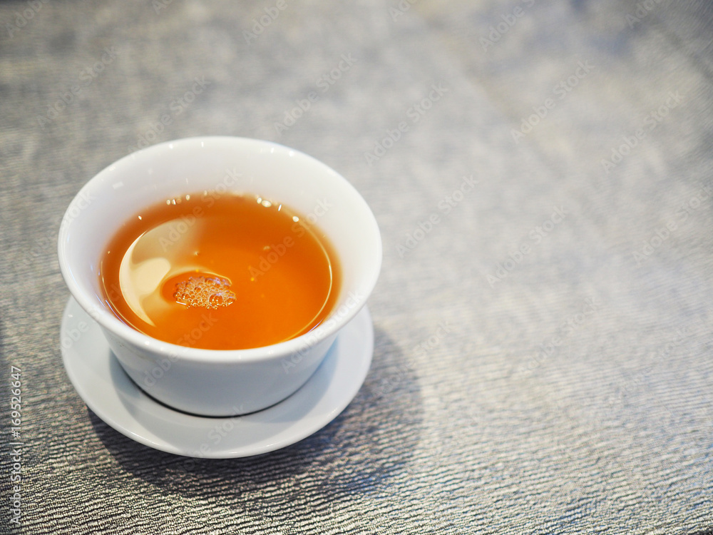 Chinese brown hot tea in white ceramic cup Chinese brown hot tea in white ceramic cup