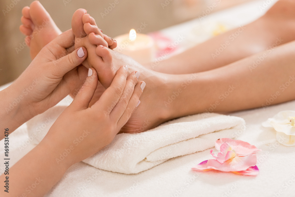 massage therapist making feet massage