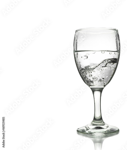 pouring water on a glass isolated on white background. Clipping path