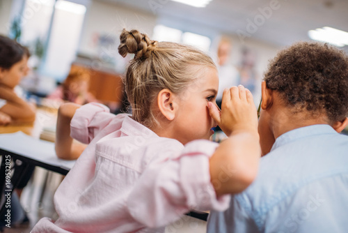 Fotografija kids gossiping at school