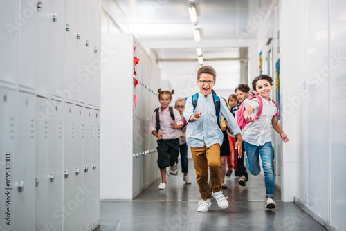 pupils running through school corridor photo