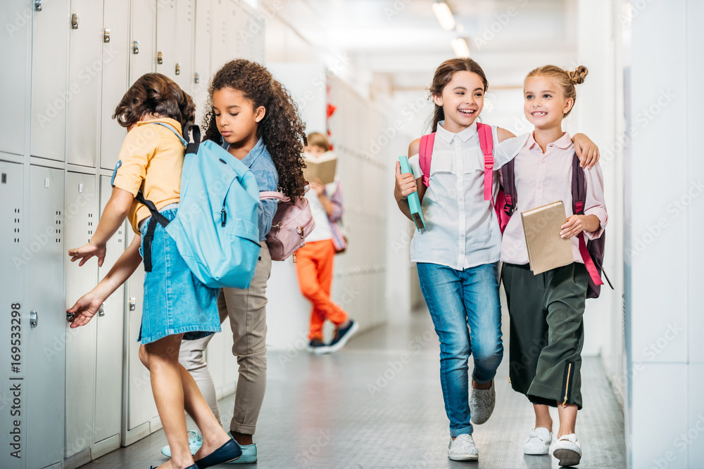 Fototapeta premium schoolgirls walking through school corridor