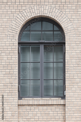 Metal window frame and white brick wall building