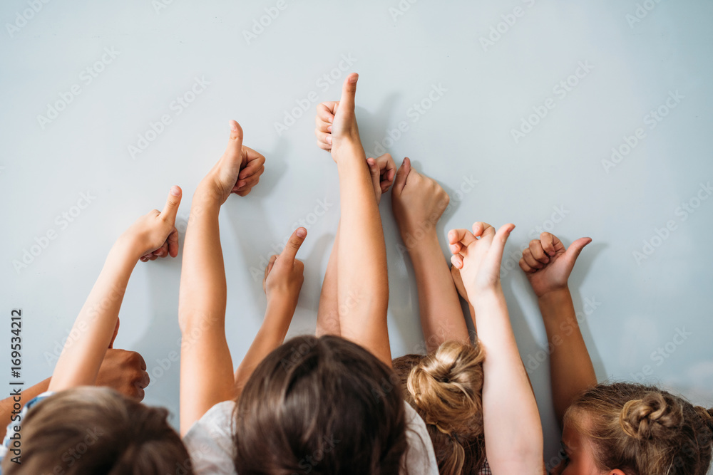 © LIGHTFIELD STUDIOS - group of kids showing thumbs up, back to school