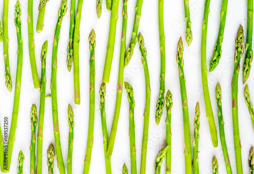 Fresh green asparagus shoots pattern, top view. Isolated over white. Food background asparagus flat lay pattern
