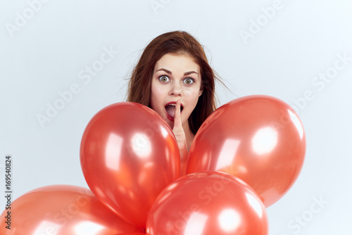 Woman holds red balloons