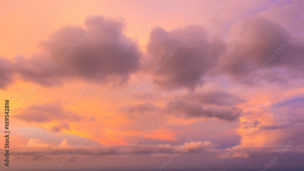 Dramatic sunset sky with clouds. Blur or defocus image.
