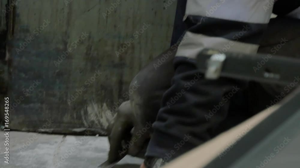 worker applying putty on a gasket worker applying putty on a gasket
