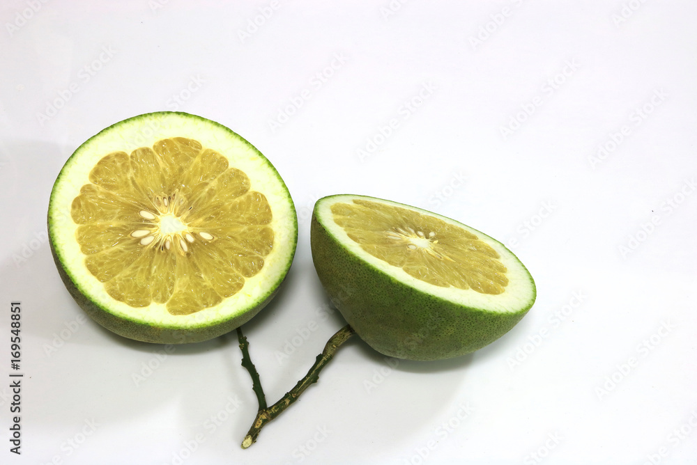 The two sliced pomelo are on white background.They are a kind of grapefruit and a dilicious thai fruit. The two sliced pomelo are on white background.They are a kind of grapefruit and a dilicious thai fruit.
