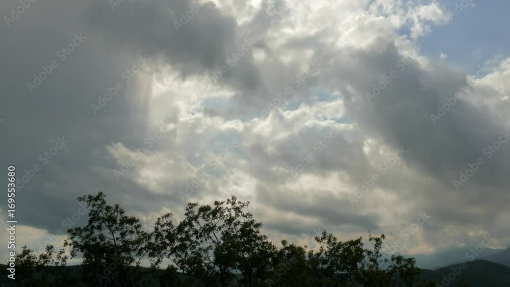 Storm clouds in blue sky / Storm clouds in blue sky over green mountains Storm clouds in blue sky / Storm clouds in blue sky over green mountains