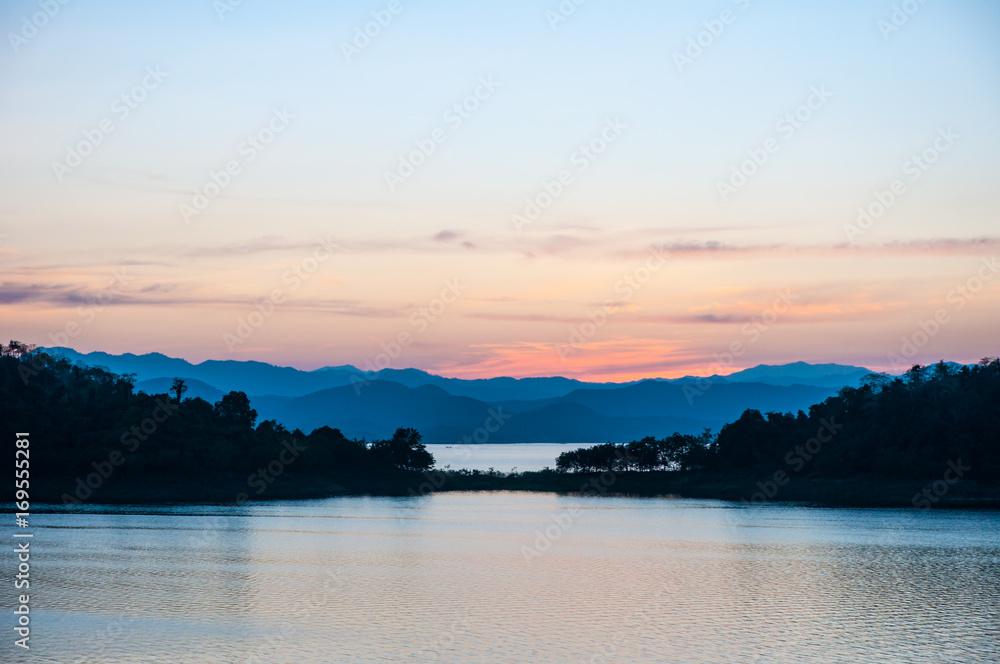 Landscape view of tranquil mountain and lake at sunset