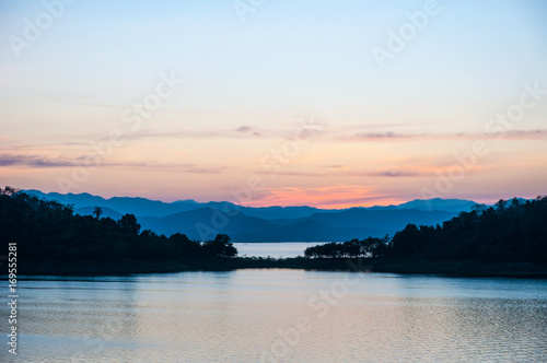 Landscape view of tranquil mountain and lake at sunset